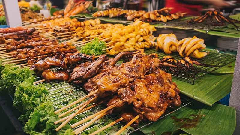 Street food Thailand Pork satay, Grilled squids in Bangkok